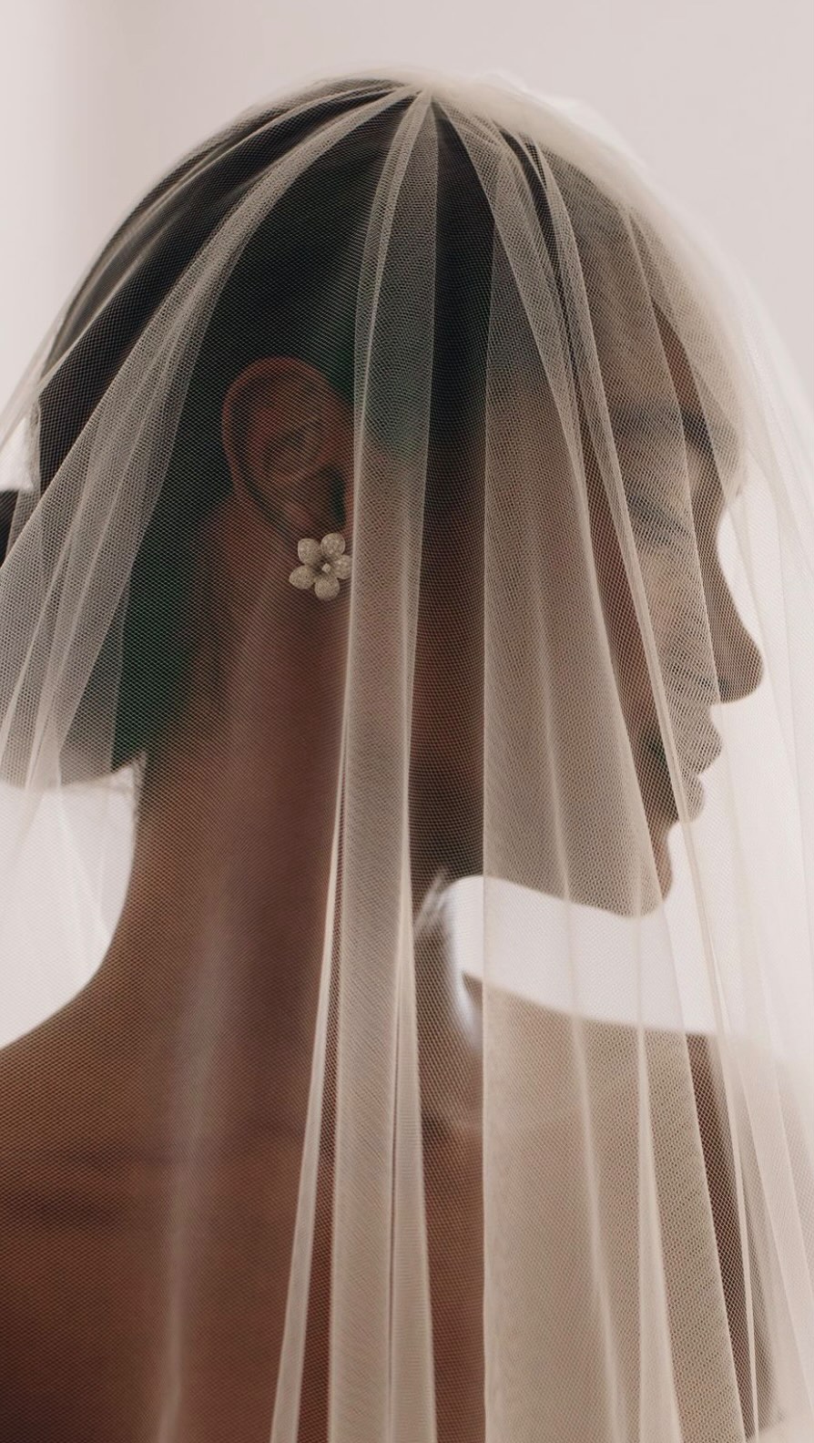 A bride beneath her veil, shared by YoursBridal&Co